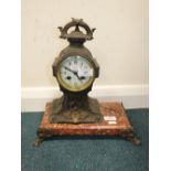 The French cast metal mantel clock on pink veined marble base