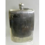 A large silver hip flask,