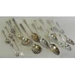 A pair of silver salad servers together with a collection of various silver spoons,