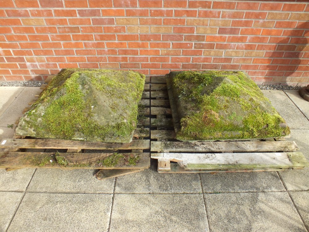 A pair of large stone gatepost pediments, each of square form low pyramid,