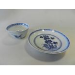 A Chinese blue and white Nanking Cargo tea bowl and saucer decorated with pine tree and rocks