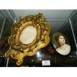 A continental porcelain oval plaque with portrait of a young lady to Rococo style gilt wood frame