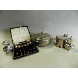 A white metal circular box and cover together with a cased set of six silver coffee spoons with
