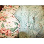 Two large boxes of material to include brightly coloured floral lined curtains,