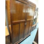 A mahogany double door fitted wardrobe with trade label for Aw-Lyn the interior with pull-out