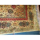 A large Indian style cream ground carpet with central rose medallion within busy floral field and