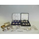 Two cased sets of silver spoons together with a silver mounted cigarette box, a silver egg cup,