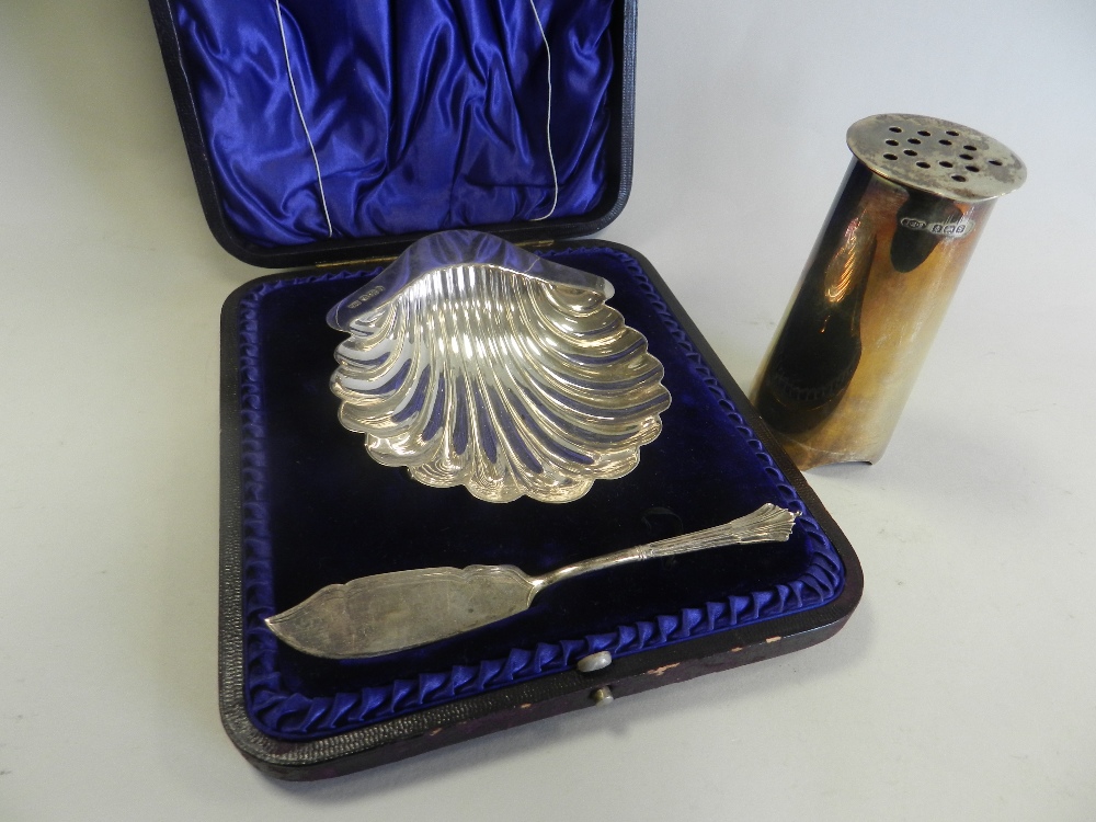 A cased silver butter dish in the form of a shell together with a silver pounce pot