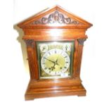An oak cased bracket clock of architectural form with typical German spring driven 8 day movement