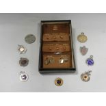 a collection of 9ct gold studs, a pair of 9ct gold cufflinks, silver fobs, a swivel fob, etc.