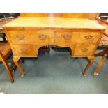 A 1930s figured walnut dressing table with two frieze drawers and two short apron drawers on