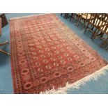 A large Tekke style claret ground rug,