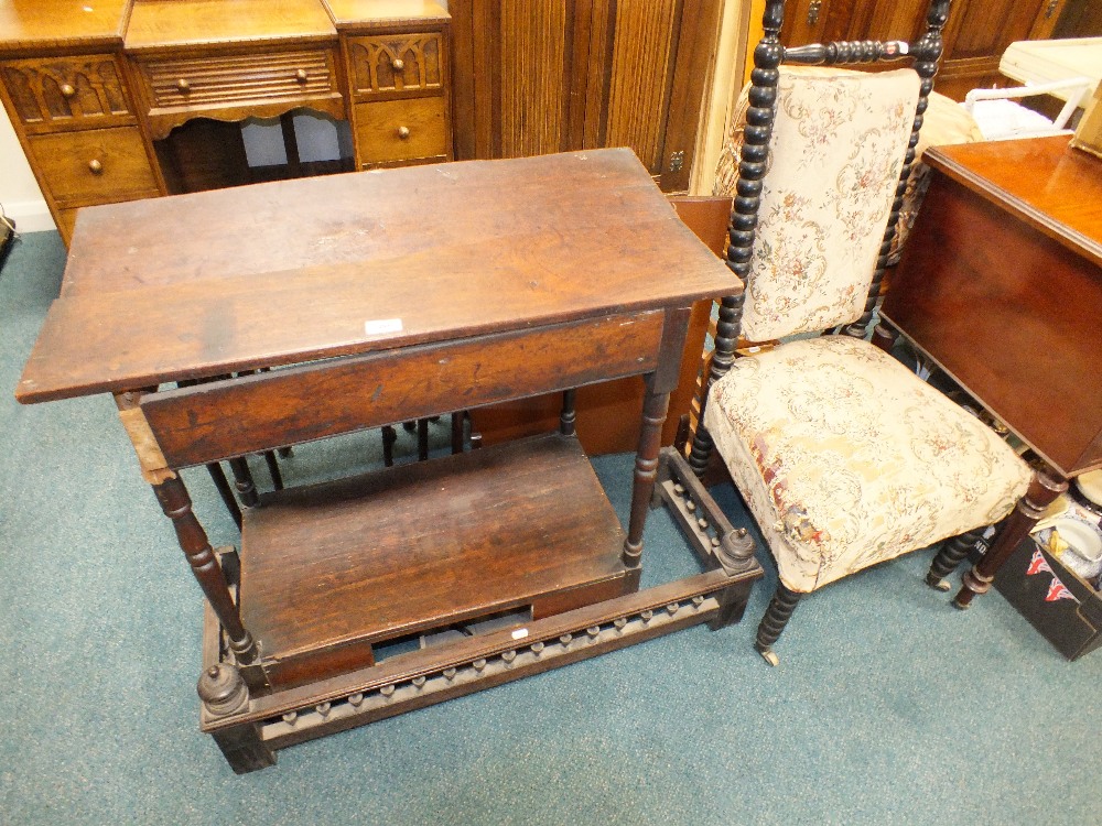 An early 19th century two tier side table with drawer below on spindle legs,