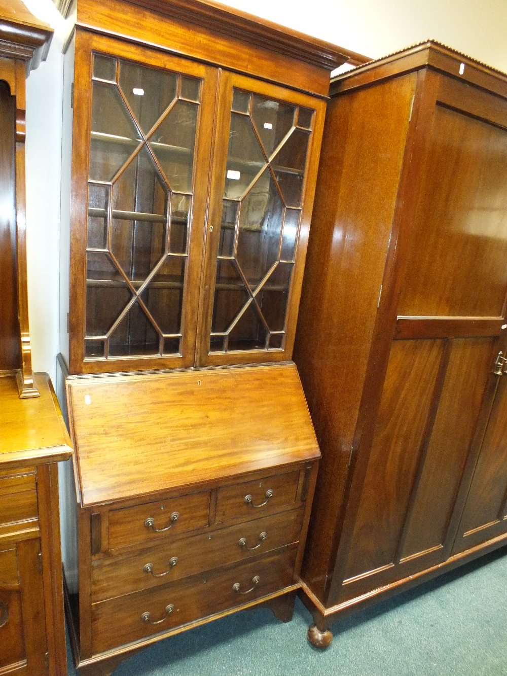 An Edwardian mahogany bureau bookcase with two astragal glazed doors above a slope front and two