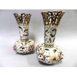 A pair of Zsolnay vases of bottle form with pierced rims,