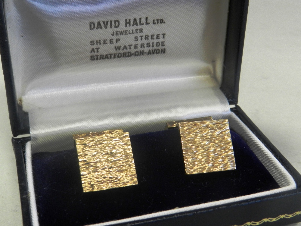 A pair of 9ct gold cufflinks each with textured bark finish