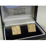 A pair of 9ct gold cufflinks each with textured bark finish