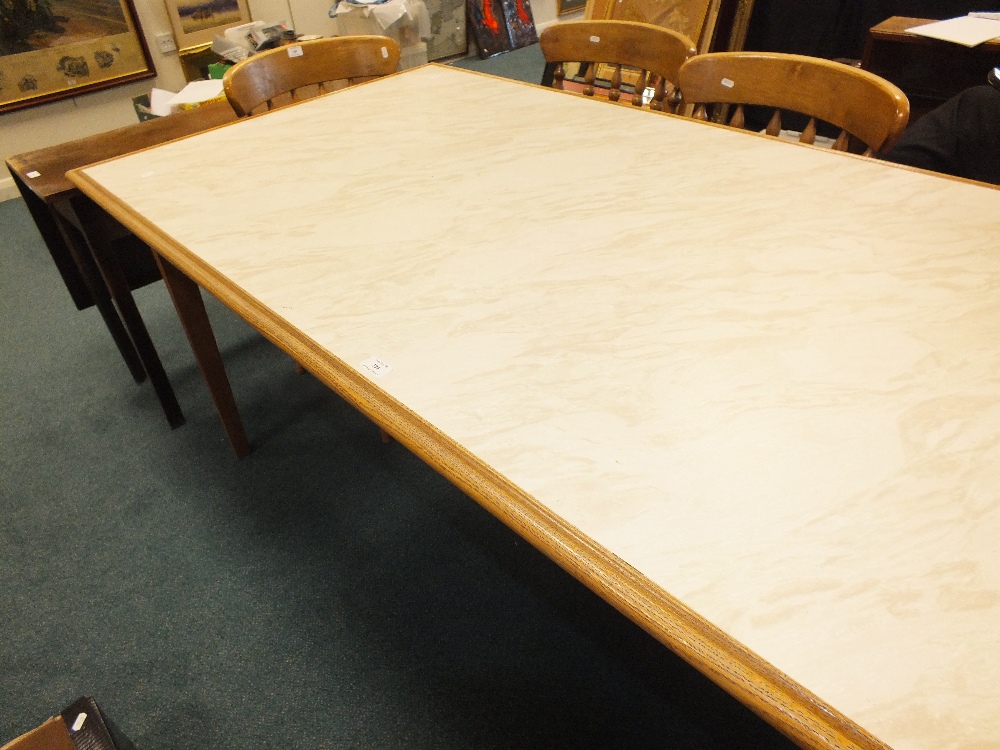 A light oak and beech kitchen table with inset marble effect MDF top on square tapering legs,