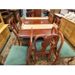 A George I style mahogany finished dining suite comprising twin pillar dining table,