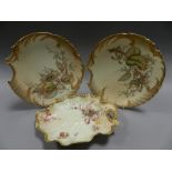 A set of four Royal Worcester blush ivory dessert plates of Rococo shell form and decorated with