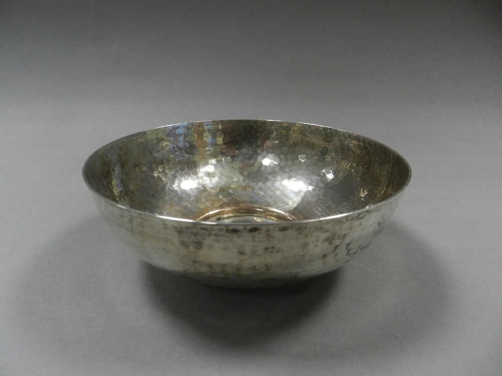 A silver circular hammered bowl,