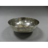 A silver circular hammered bowl,