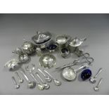A collection of various silver condiments to include a silver pepperette in the form of a barrel,