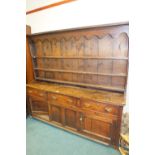 A George III oak dresser and associated rack,