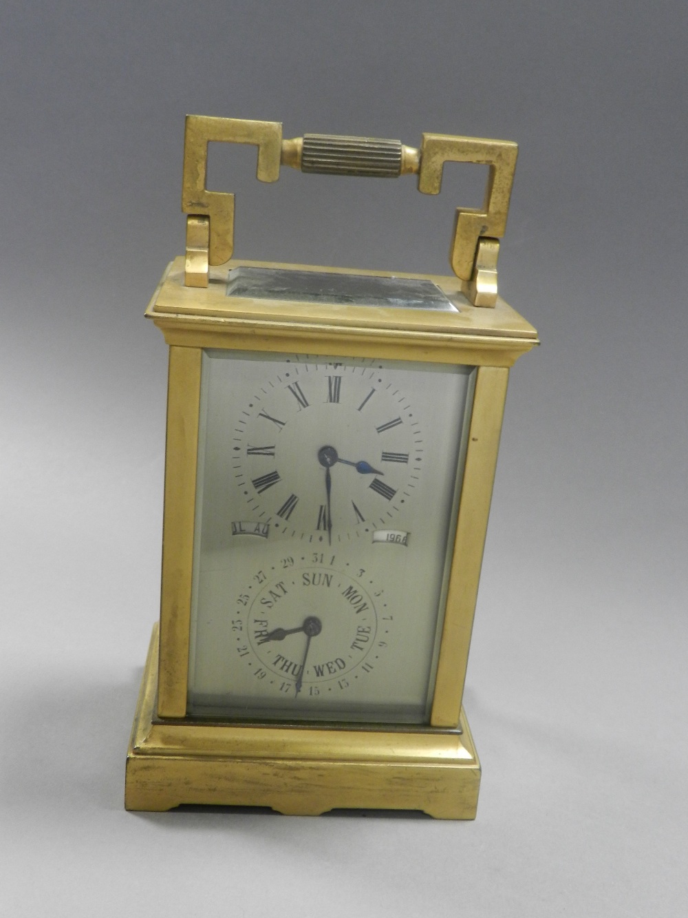 A carriage timepiece with Roman numeral dial and a further subsidiary calendar dial