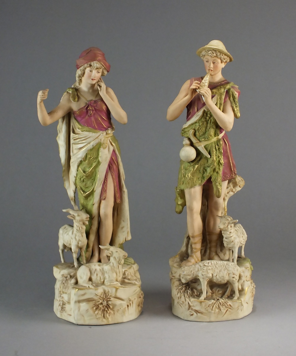 A pair of early 20th century Royal Dux figures of a shepherd and female goatherd,