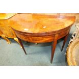 A George III mahogany and inlaid demi lune tea table,