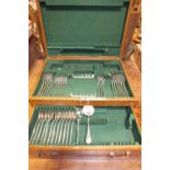 An oak cased part canteen of EPNS flat ware including dinner and dessert forks,