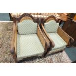 A pair of early 20th century walnut frame single bergere armchairs,