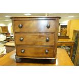 A Victorian miniature mahogany chest of three drawers with canted sides and on bun feet, 30cm wide,