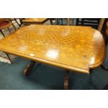 An Italian style walnut and inlaid coffee table with geometric and foliate designed top and frieze