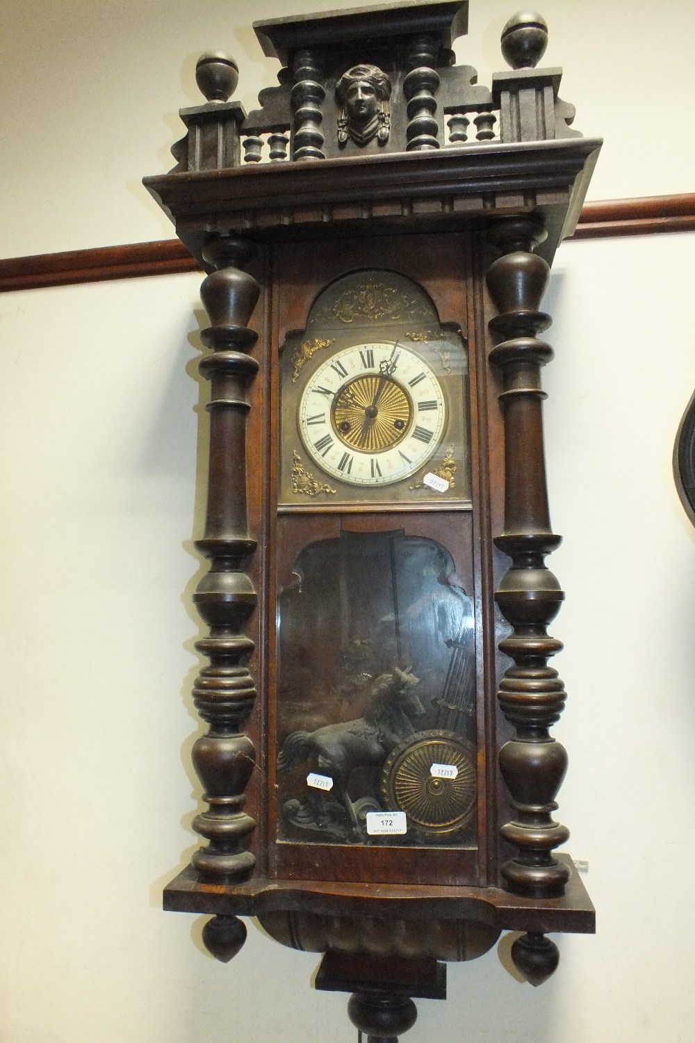 A late 19th century mahogany Vienna type wall clock with typical spring driven movement,