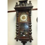 A late 19th century mahogany Vienna type wall clock with typical spring driven movement,