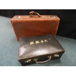 A mid 20th century embossed green leather suitcase with brass fitting and a gilt tooled monogram