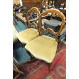 A pair of Victorian balloon back parlour chairs with later upholstered seats