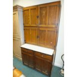 An oak Easiwork kitchen cabinet with four double doors above enclosing a fitted interior over an