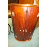 A 19th century mahogany bowfront double door corner cabinet with shelves to the interior, 60cm wide,