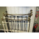 A white painted wrought iron and brass single bed frame and another metal single bed frame,