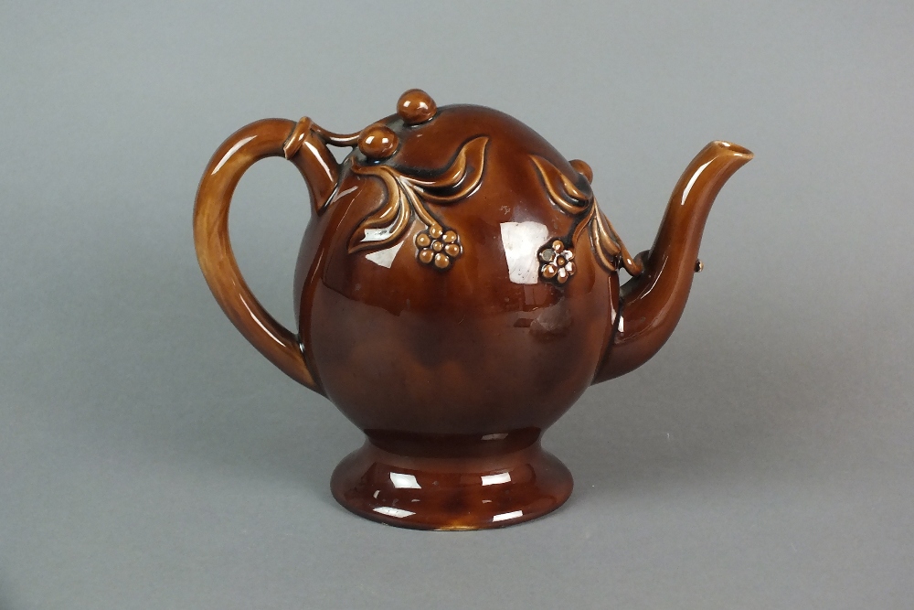 A Copeland and Garrett Cadogan treacle glazed teapot, with applied floral and fruit decoration,