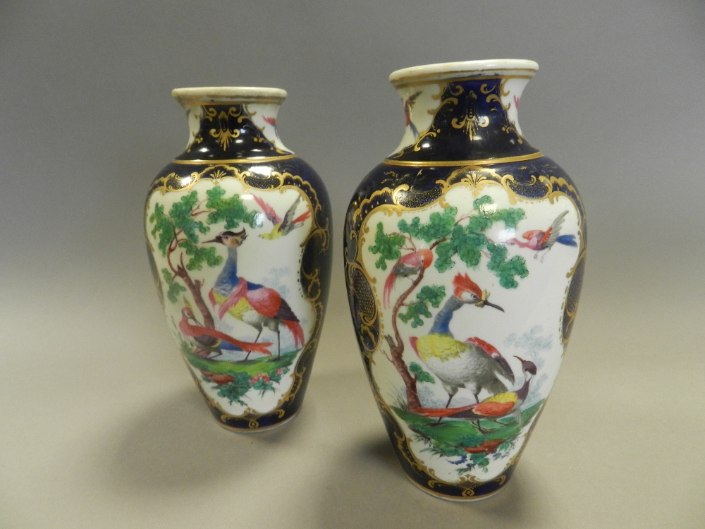 A pair of early 20th century Samson Worcester porcelain style vases decorated with exotic birds