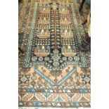 A North West Persian rug the field centred by a leafy tree motif within hooked ghul borders,