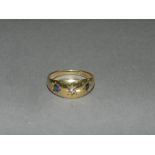 An 18ct gold three stone sapphire and diamond ring