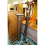 Two mahogany torchere stands, each with leaf capped reeded column and on three down-curved feet,