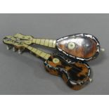 A tortoiseshell and abalone inlaid miniature model of a guitar together with a further instrument