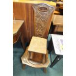 An oak framed spinning chair with foliate carved panel back and an elm seat four leg milking stool