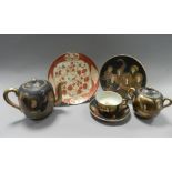 A Japanese Satsuma tea set comprising six cups and saucers, five side plates, a teapot, sugar box,